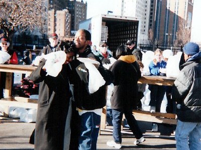 Volunteers serving guests at outdoor tables at St. John's Church